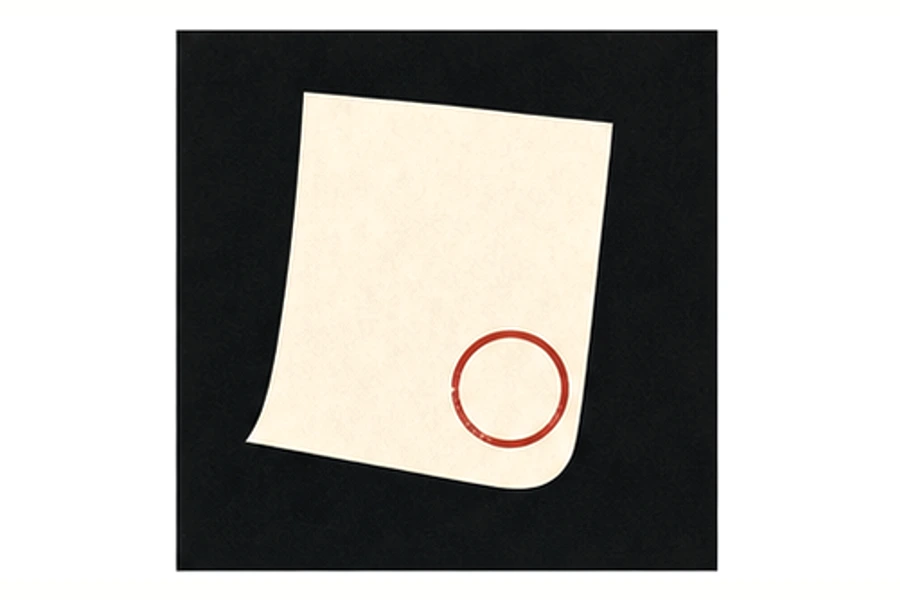 Blank paper receipt sliding under a red paperweight.